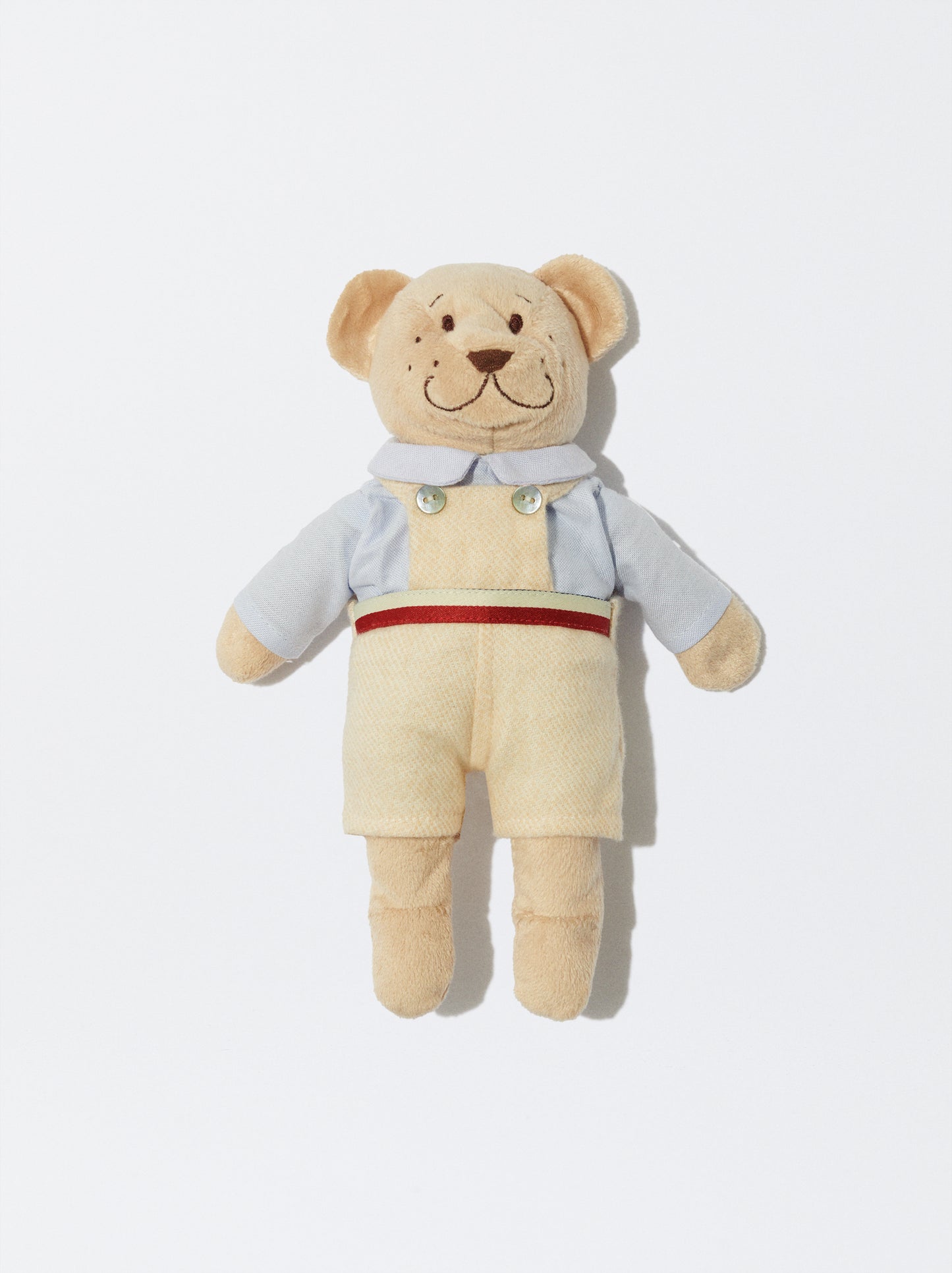 Tom com jardineiras bege