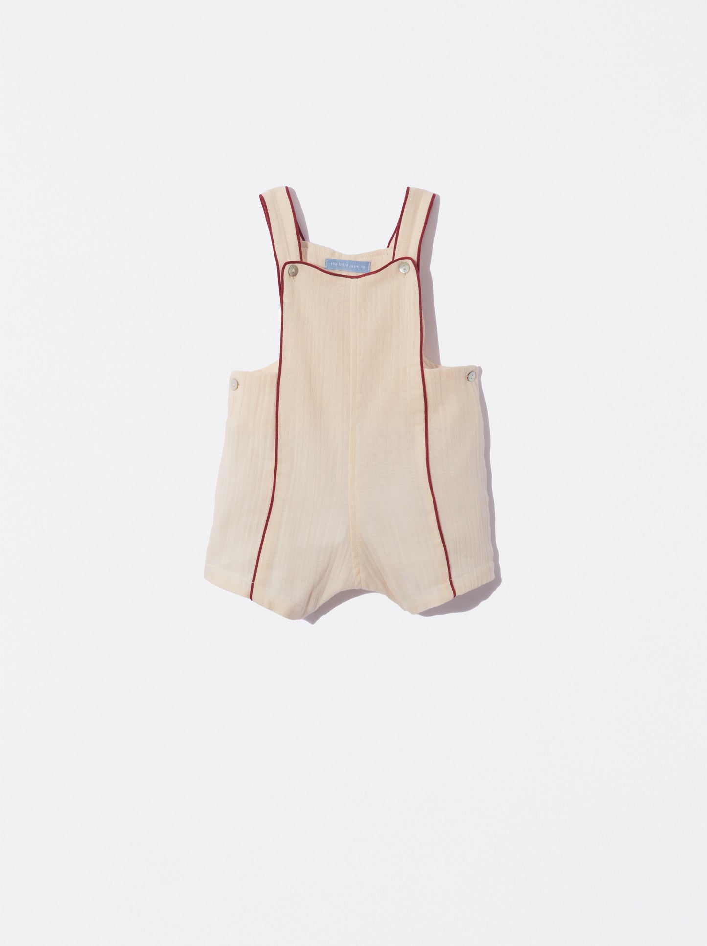 Jardineira bege com detalhe bordeaux