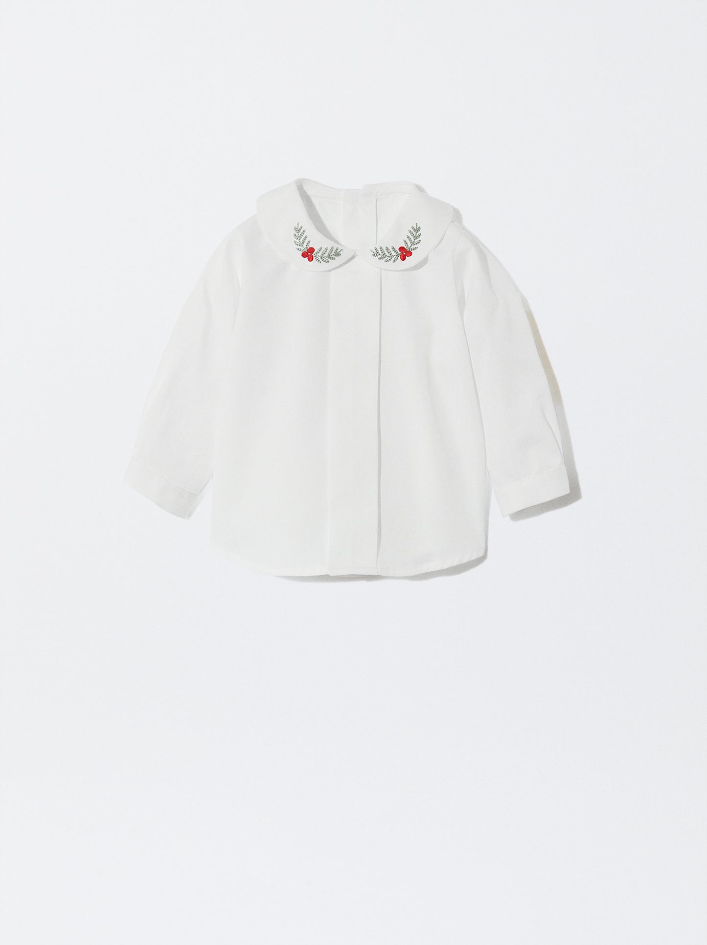 Blusa com gola redonda e bordado de azevinho